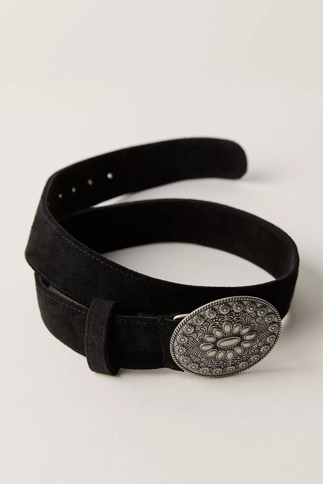 Black belt with a decorative silver buckle on a light gray background