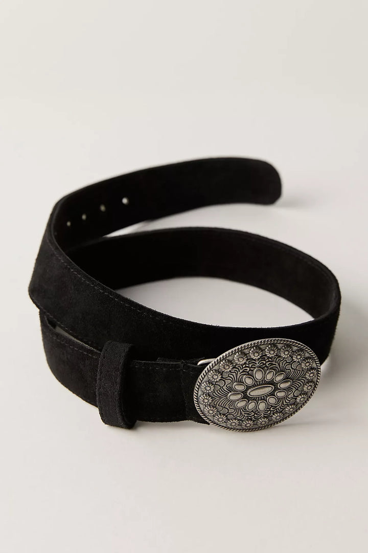 Black belt with a decorative silver buckle on a light gray background